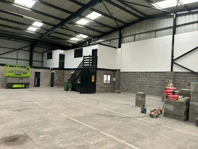 Interior of a commercial unit mid fit-out with mezzanine office, by G&M Building Solutions