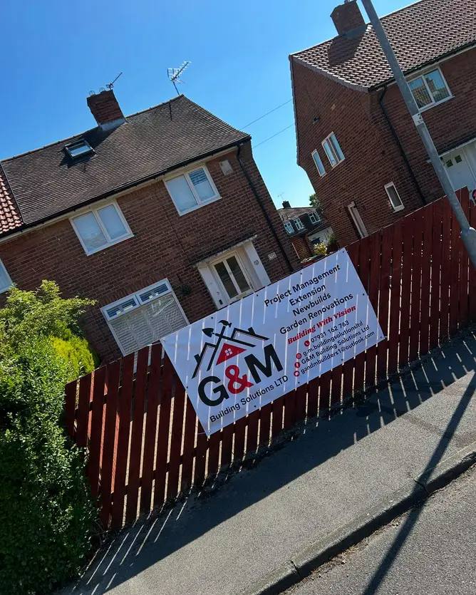 G&M Building Solutions site banner outside a brick semi-detached house in east Leeds