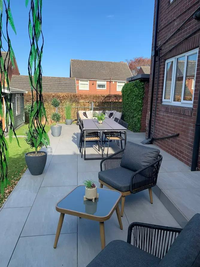 Porcelain patio with outdoor dining set built by G&M Building Solutions in Leeds
