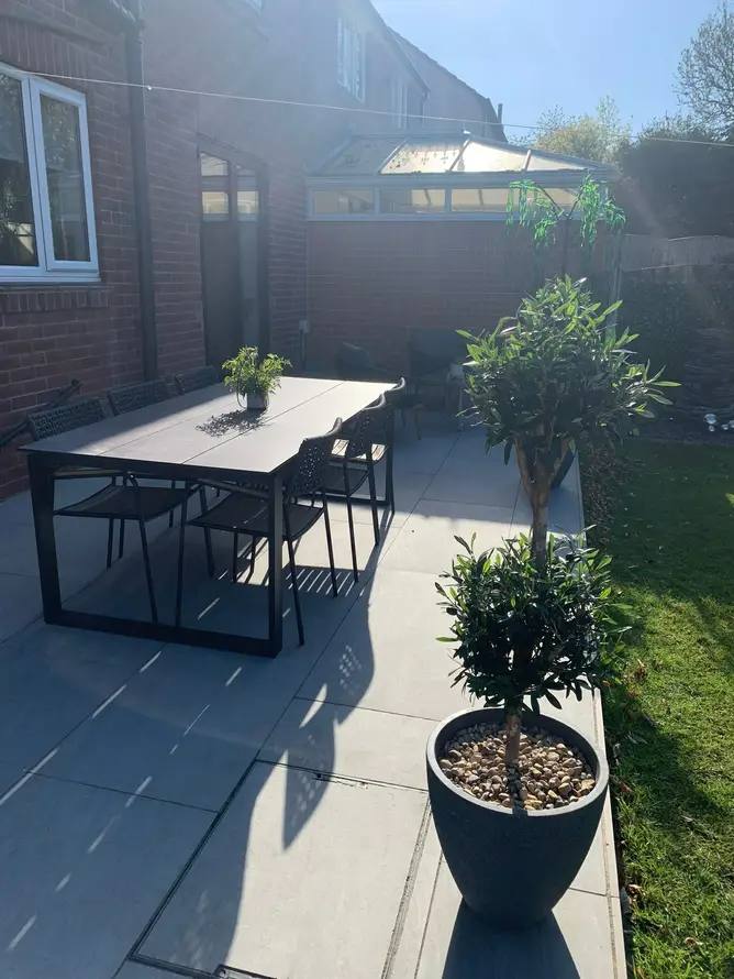 New porcelain patio beside a conservatory, built by G&M Building Solutions in Leeds