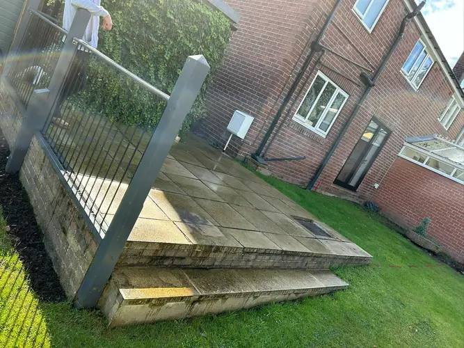 Raised stone patio with steel balustrade built by G&M Building Solutions