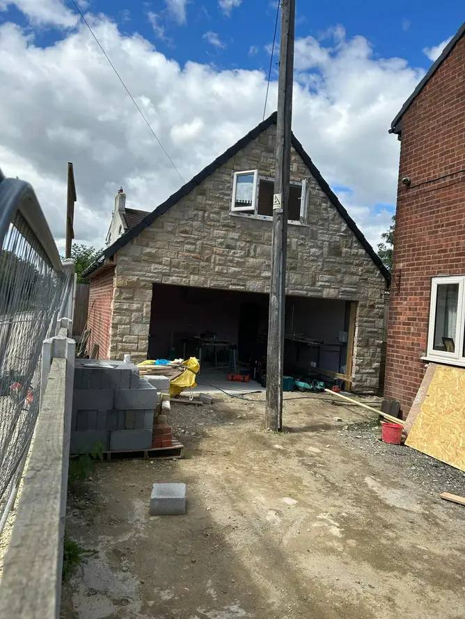 Stone-faced double garage under construction by G&M Building Solutions near Leeds