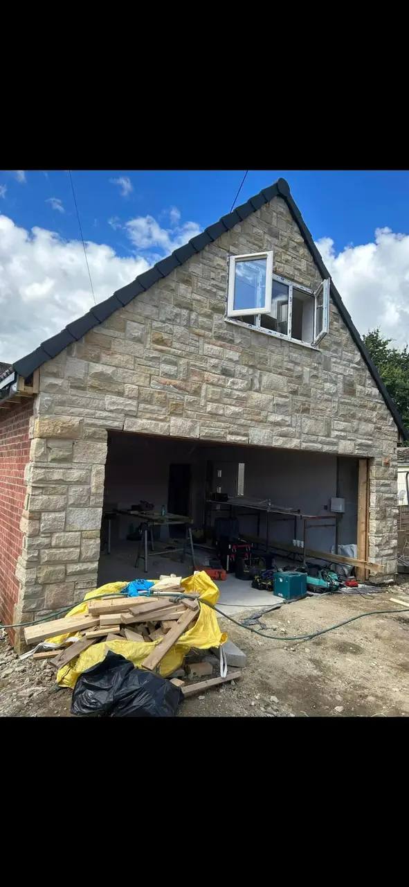 Front elevation of a stone-faced double garage built by G&M Building Solutions